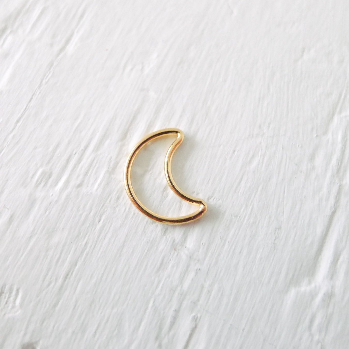 Elegant gold moon wire link charm, perfect for adding a celestial touch to jewelry, including necklaces, bracelets, and earrings.